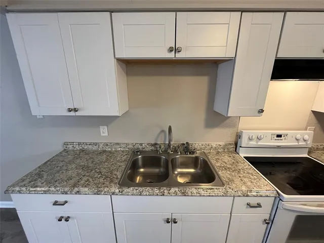 a kitchen with a sink and cabinets