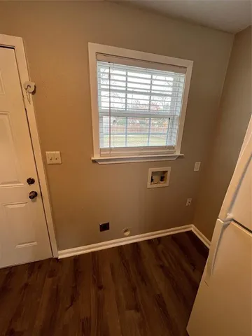 a view of a room with wooden floor and window