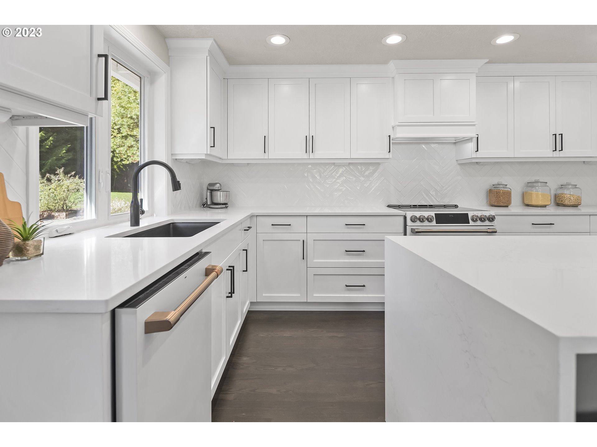23918 Northwest Meuller Road Ridgefield, WA 98642 - Photo 7 of 32 a kitchen with kitchen island white cabinets appliances and a sink
