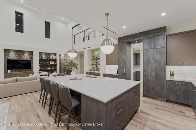 a living room with furniture a chandelier and a dining table