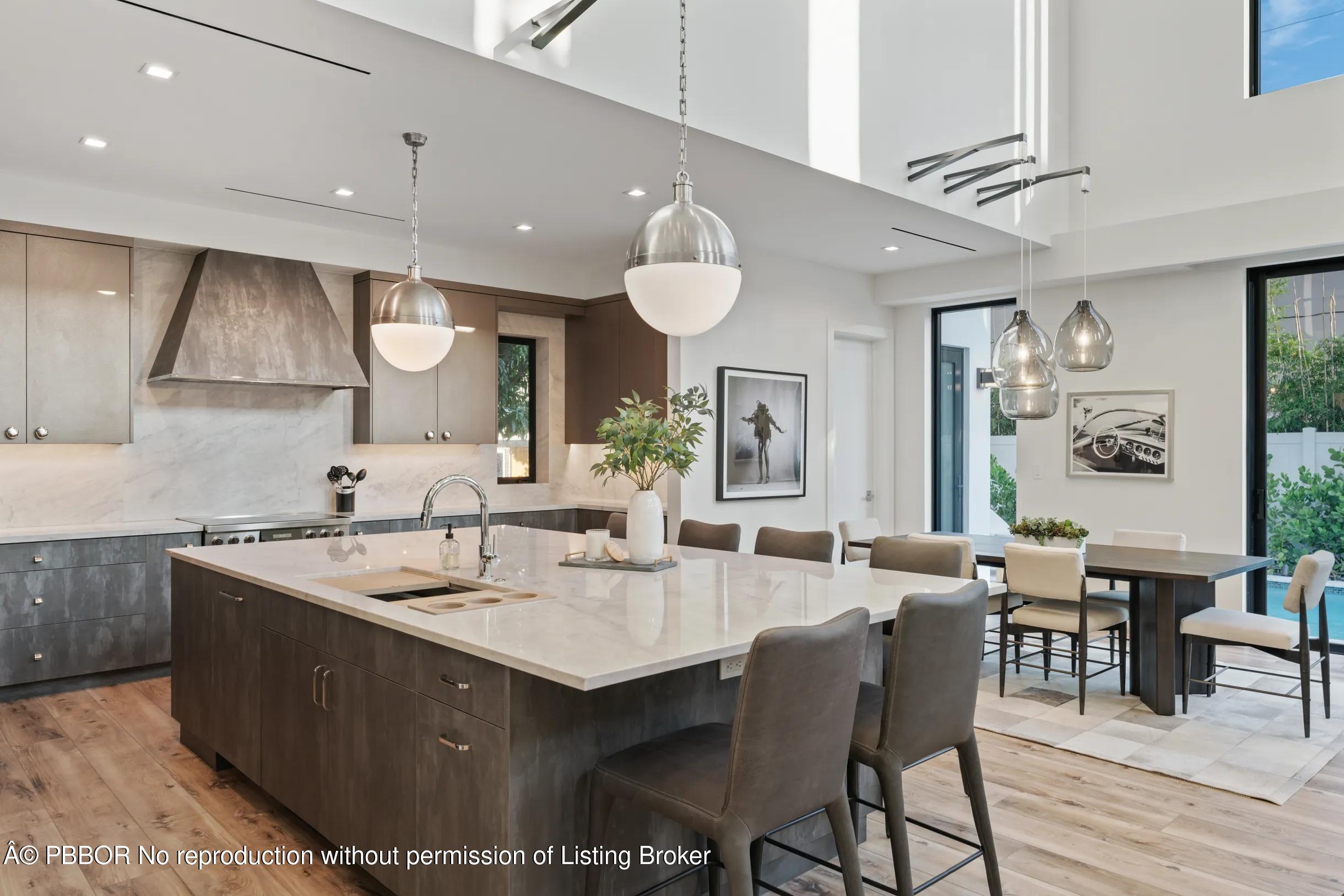 Undisclosed Address West Palm Beach, FL 33407 - Photo 13 of 57 a kitchen with a dining table chairs sink and white cabinets