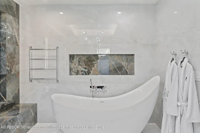 a large white bed in a white room