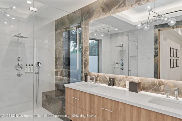a bathroom with a sink mirror and a bath tub