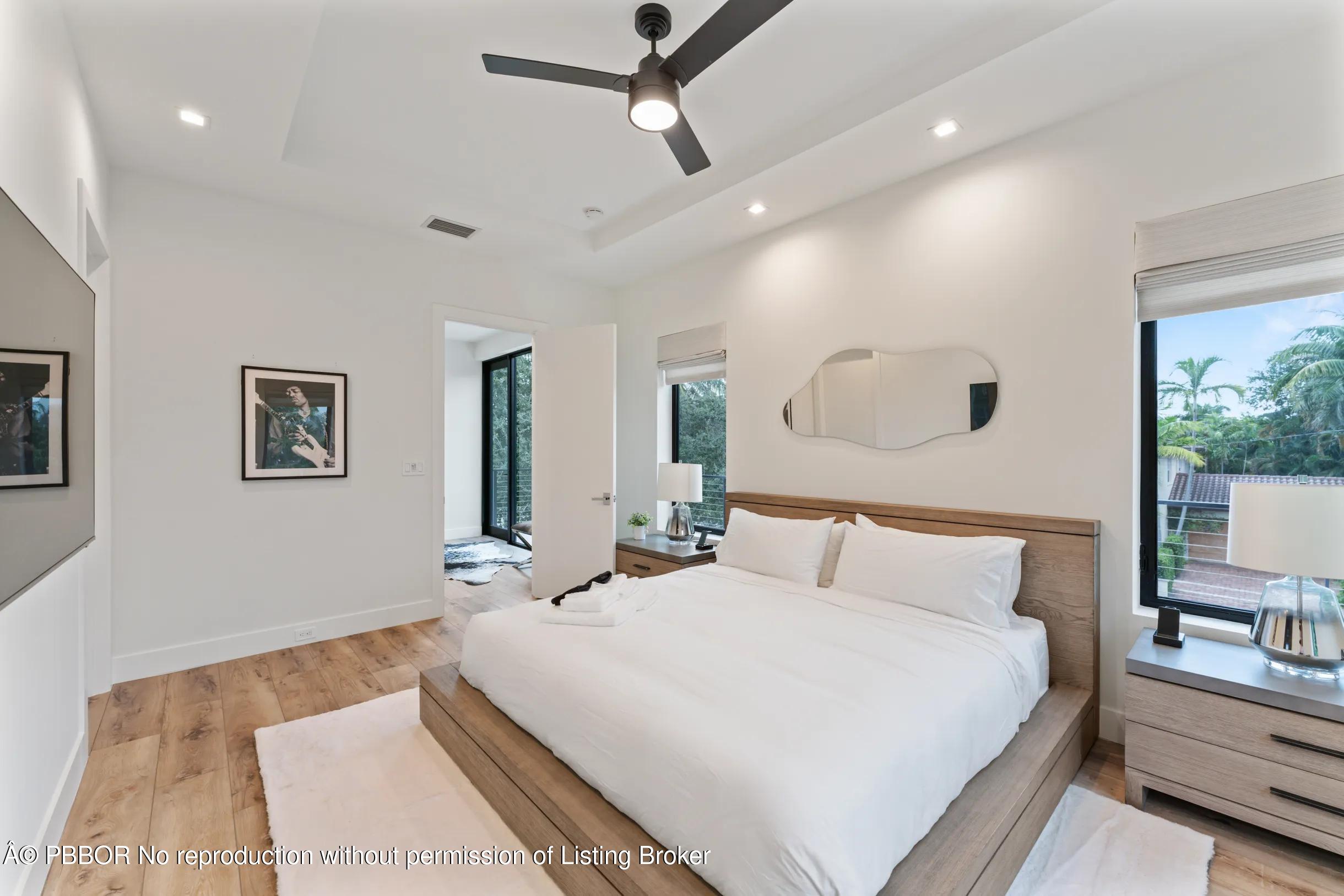 Undisclosed Address West Palm Beach, FL 33407 - Photo 29 of 57 a bedroom with a large bed and a chandelier