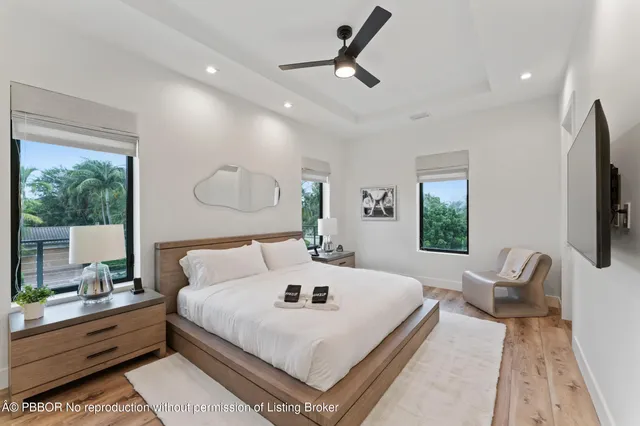 a bedroom with a large bed and a chandelier
