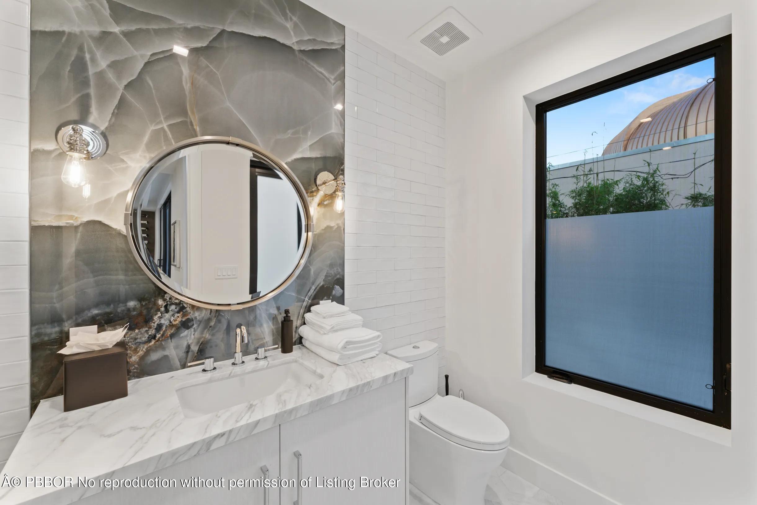 Undisclosed Address West Palm Beach, FL 33407 - Photo 50 of 57 a bathroom with a granite countertop toilet sink and mirror