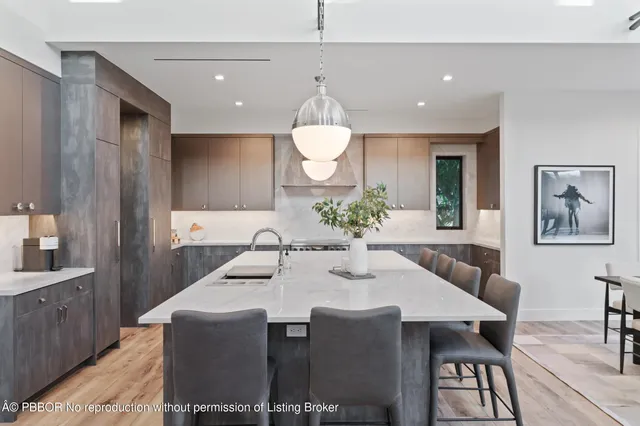 a large kitchen with a table and chairs