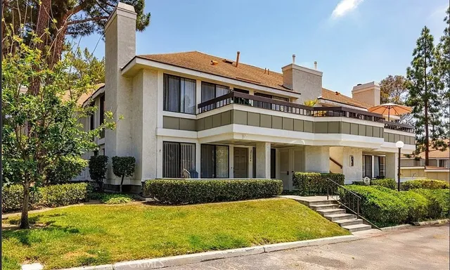 a view of a patio with table and chairs potted plants and large tree