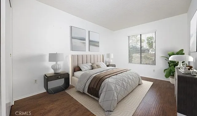 a bedroom with a bed and a large window