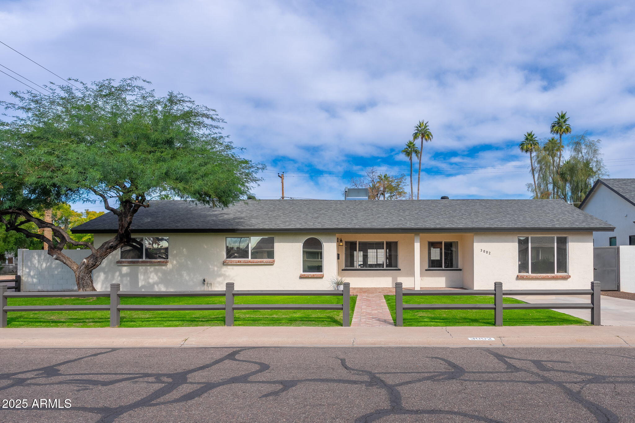 3002 East Whitton Avenue Phoenix, AZ 85016 - Photo 1 of 32 a front view of a house with a yard and a garage