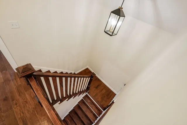 a view of staircase with wooden floor
