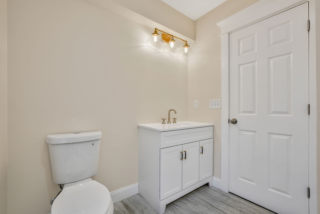16 Water Street, Unit D Freetown, MA 02702 - Photo 15 of 24 a bathroom with a toilet a sink and mirror