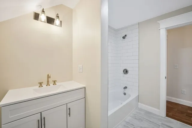 a bathroom with a sink a mirror and a bathtub