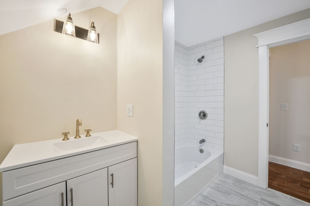 16 Water Street, Unit D Freetown, MA 02702 - Photo 17 of 23 a bathroom with a sink a mirror and a bathtub