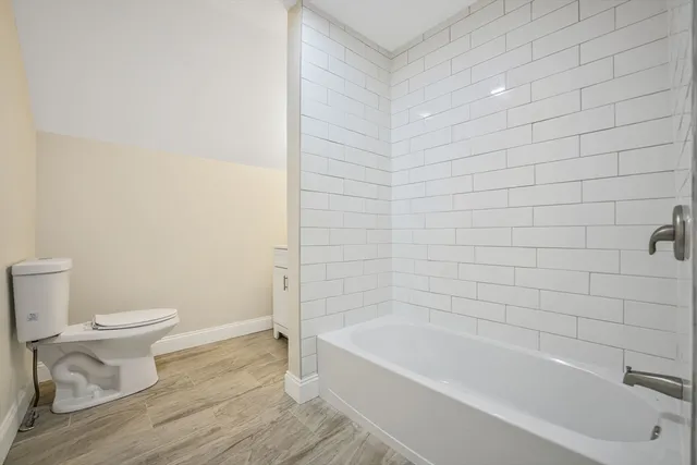 a bathroom with a toilet and bathtub