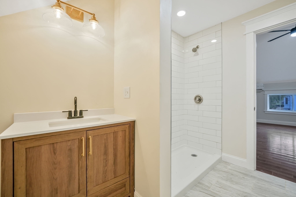 16 Water Street, Unit D Freetown, MA 02702 - Photo 19 of 23 a bathroom with a sink a shower and a mirror