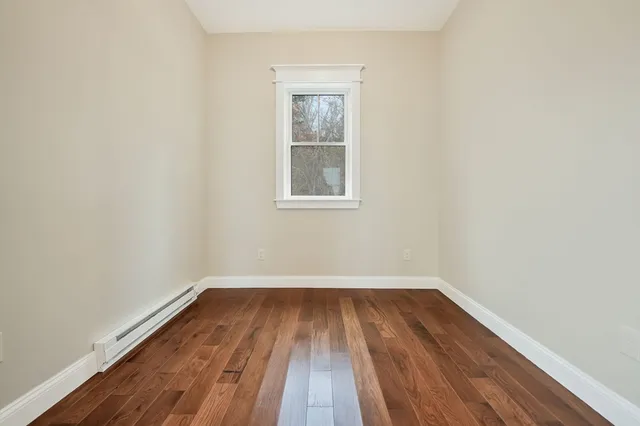 a view of a room with wooden floor and window