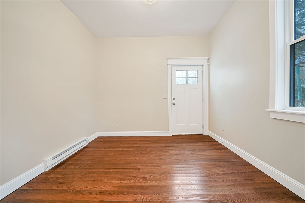 16 Water Street, Unit D Freetown, MA 02702 - Photo 3 of 24 a view of an empty room with wooden floor and a window
