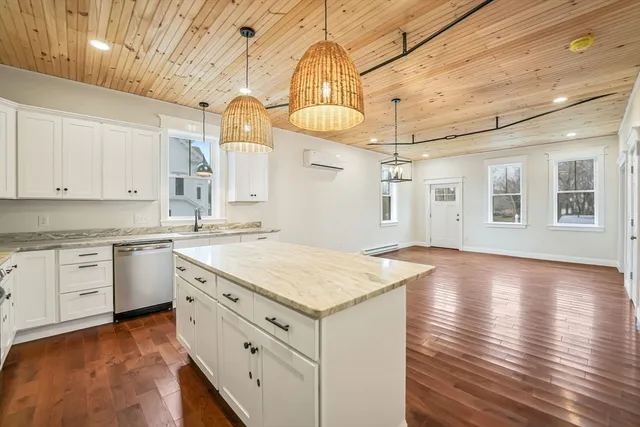 a kitchen with granite countertop white cabinets and white appliances