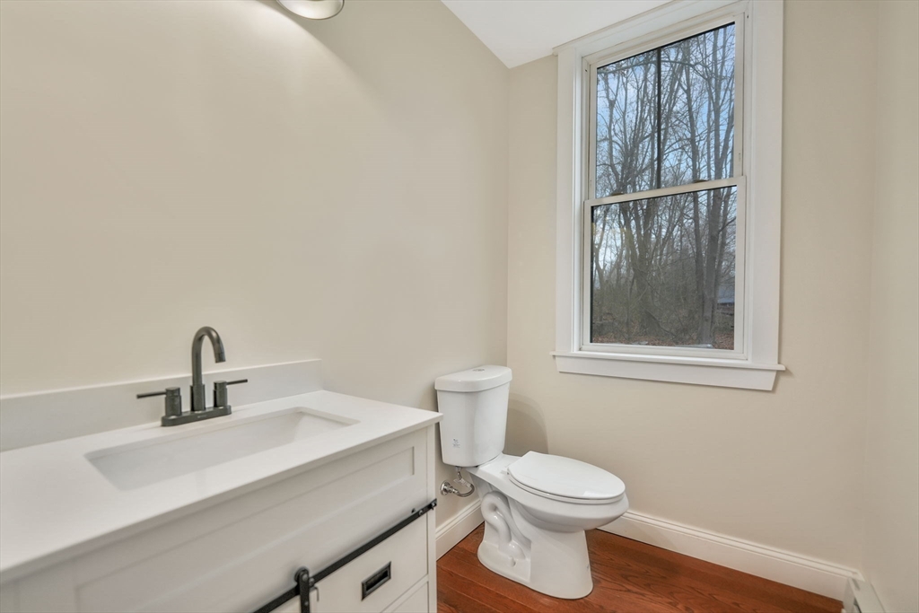 16 Water Street, Unit D Freetown, MA 02702 - Photo 8 of 24 a bathroom with a toilet a sink and mirror