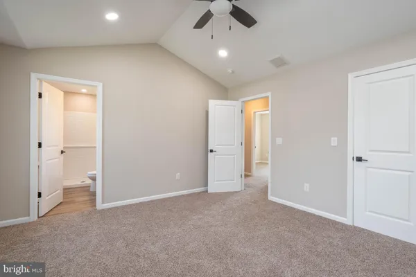 an empty room with a empty space and a ceiling fan