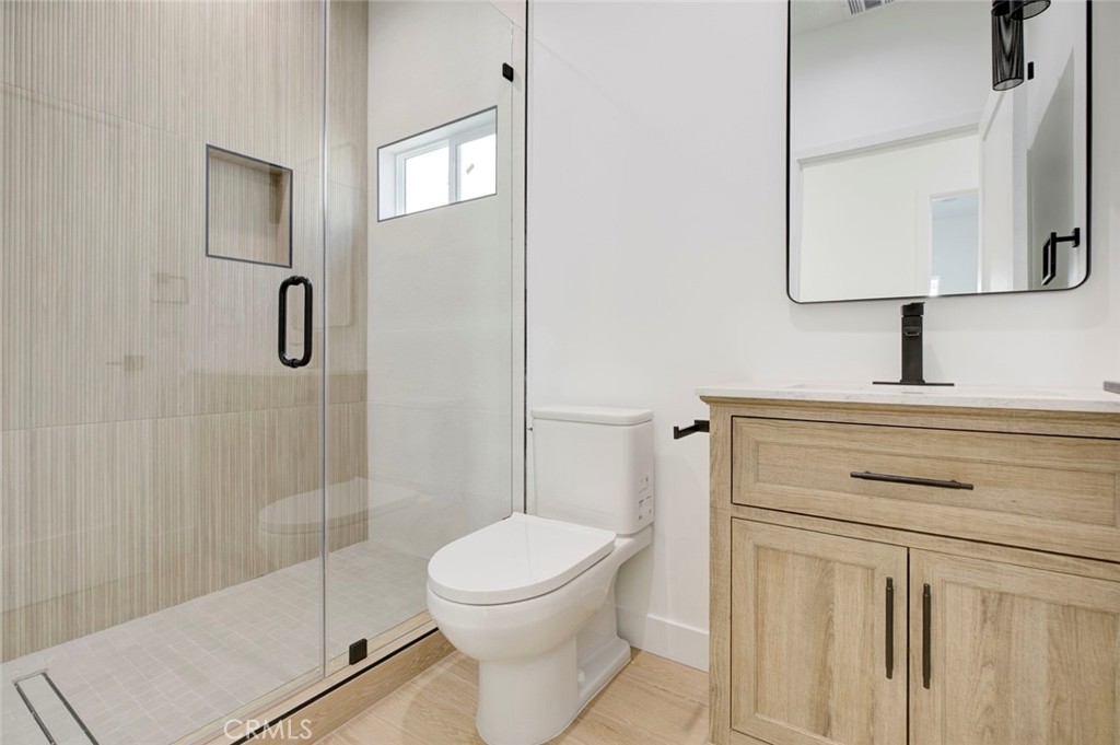 2240 North Keystone Street Burbank, CA 91504 - Photo 15 of 24 a bathroom with a toilet sink vanity and shower