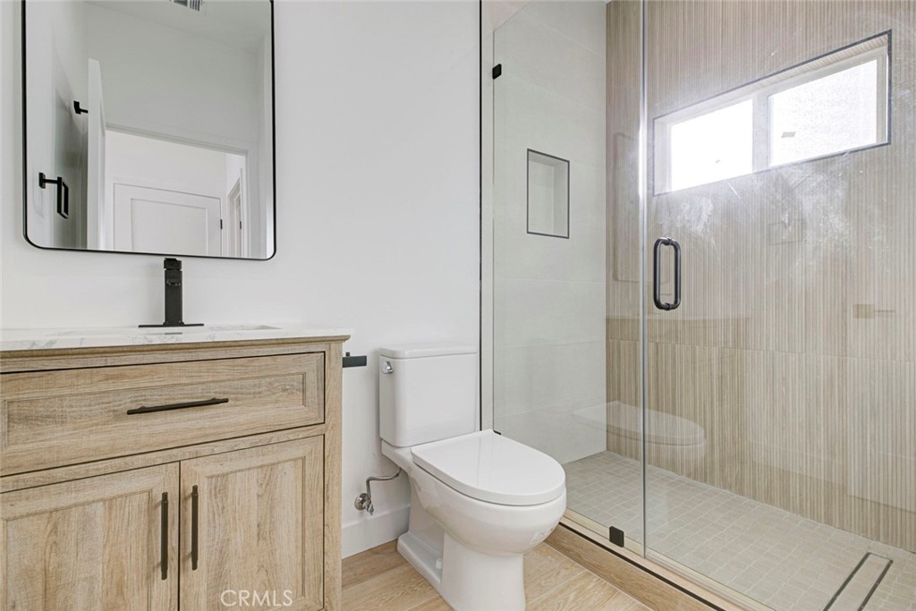2240 North Keystone Street Burbank, CA 91504 - Photo 20 of 24 a bathroom with a toilet sink vanity and mirror