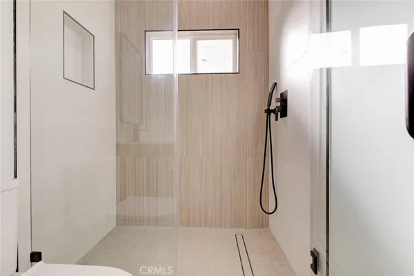 a bathroom with a glass shower door