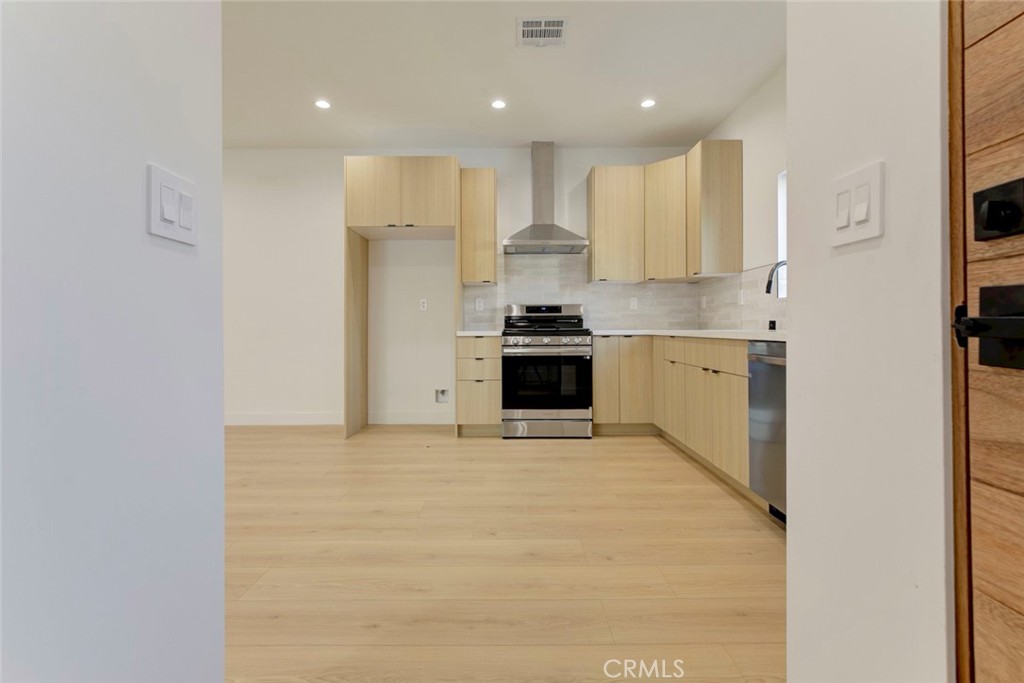 2240 North Keystone Street Burbank, CA 91504 - Photo 5 of 24 a kitchen with stainless steel appliances granite countertop a stove a sink and a refrigerator