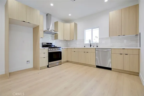 a kitchen with stainless steel appliances a sink and a refrigerator