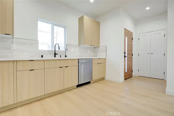 a view of a kitchen with white cabinets