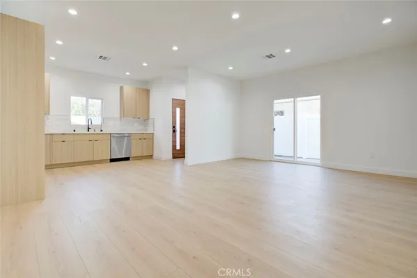 a view of kitchen with refrigerator and window