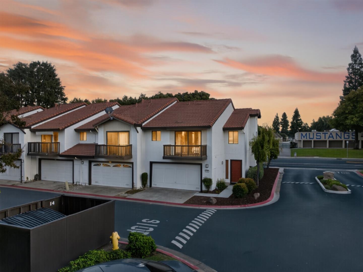 a front view of house and yard with swimming pool and outdoor seating