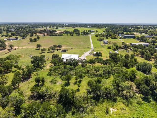 a bathroom with a granite countertop sink mirror and shower