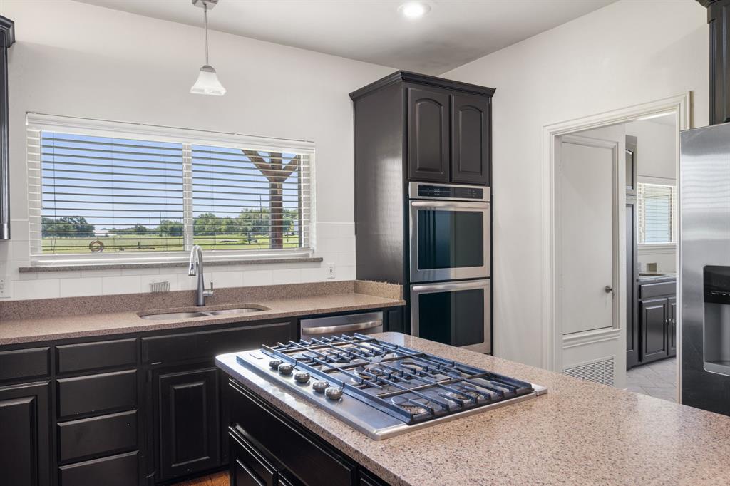 510 South Swanson Road Mineral Wells, TX 76067 - Photo 15 of 38 a kitchen with a sink stove and refrigerator