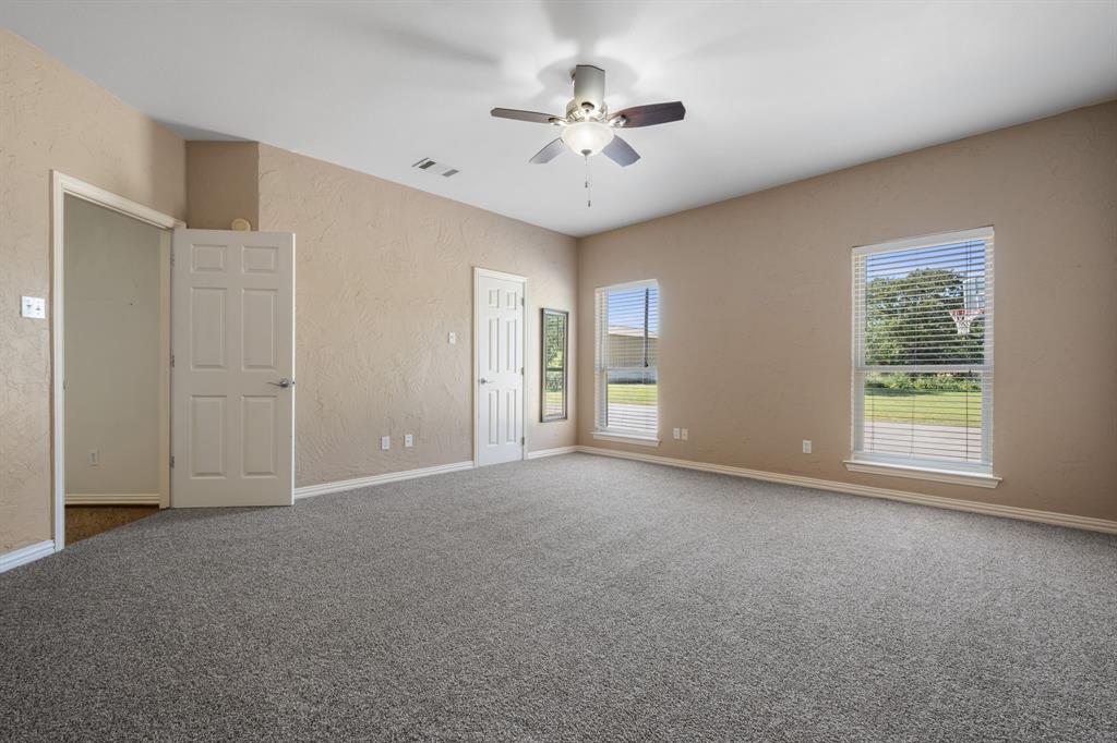 510 South Swanson Road Mineral Wells, TX 76067 - Photo 18 of 38 a view of a livingroom with a ceiling fan and window