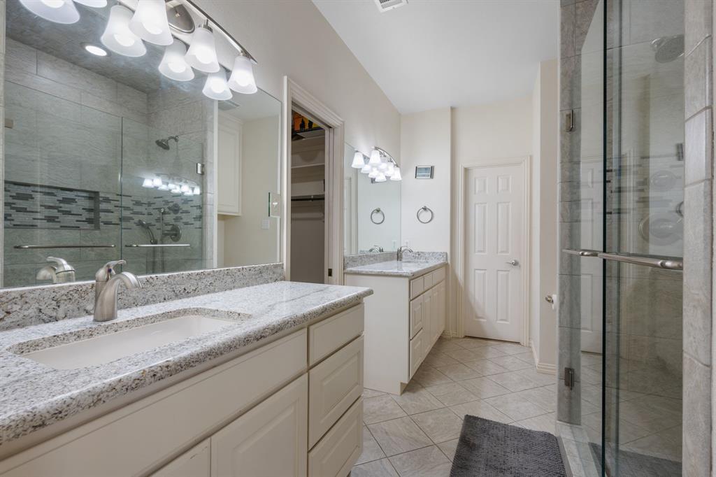 510 South Swanson Road Mineral Wells, TX 76067 - Photo 19 of 38 a bathroom with a granite countertop sink mirror and shower