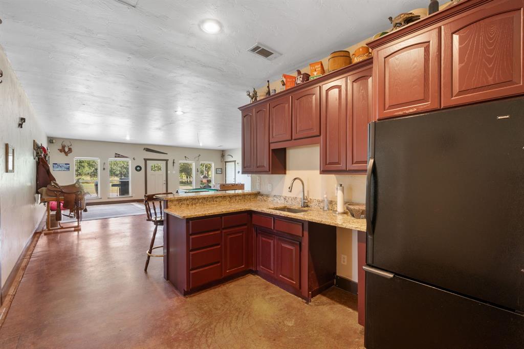 510 South Swanson Road Mineral Wells, TX 76067 - Photo 29 of 38 a kitchen with sink cabinets and wooden floor
