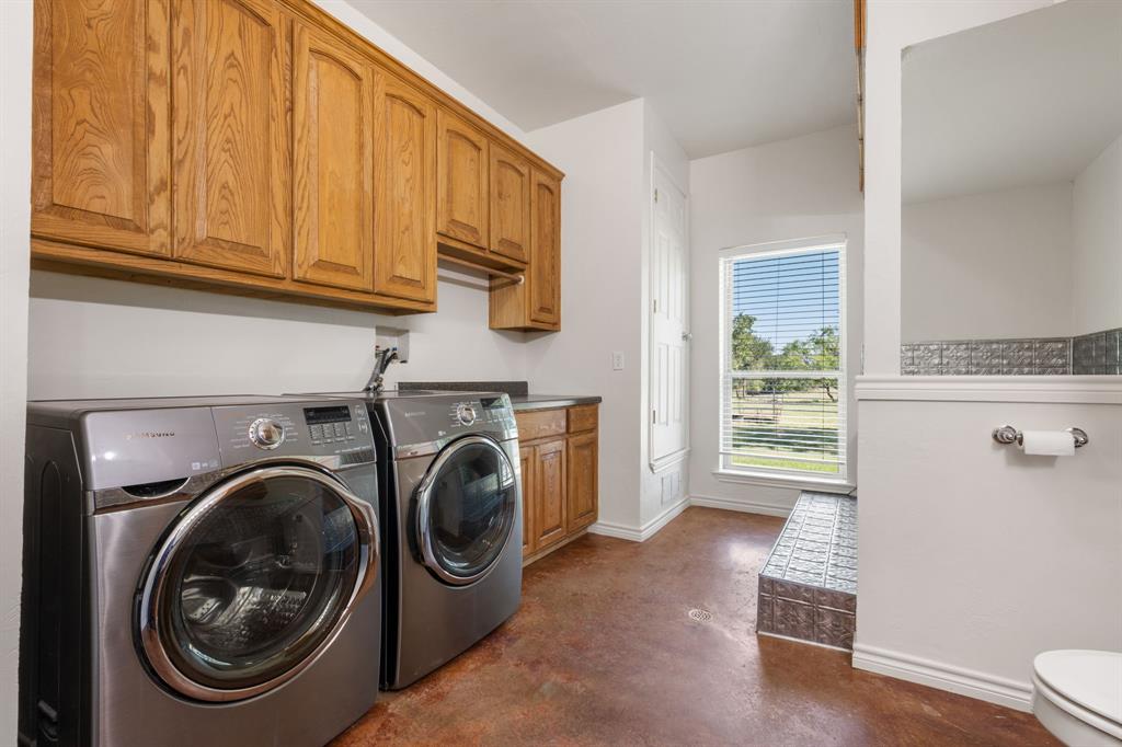 510 South Swanson Road Mineral Wells, TX 76067 - Photo 34 of 38 a view of a storage & utility room with washer and dryer