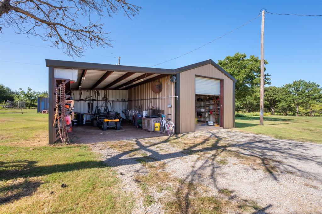 510 South Swanson Road Mineral Wells, TX 76067 - Photo 5 of 38 a view of a house with a patio and a yard