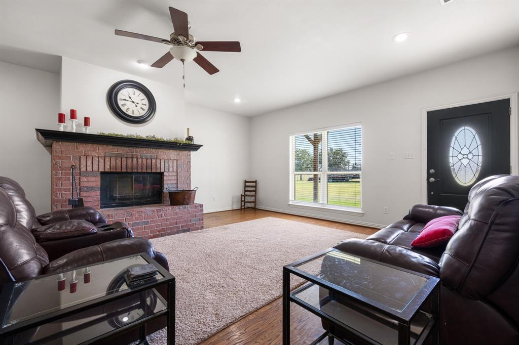510 South Swanson Road Mineral Wells, TX 76067 - Photo 10 of 38 a living room with furniture a window and a fireplace