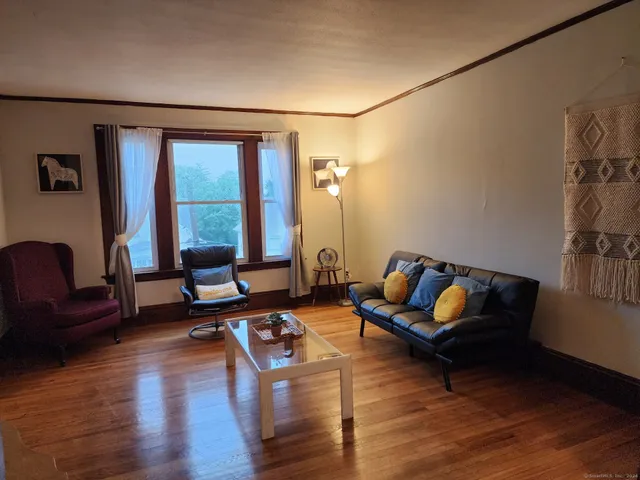 a living room with furniture and floor to ceiling window