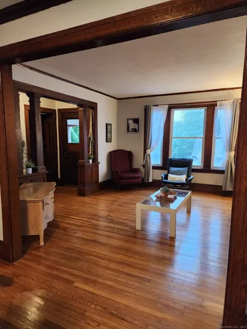 a living room with furniture window and wooden floor