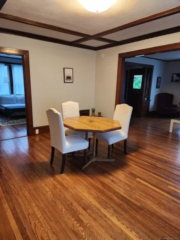 a dining room with furniture and wooden floor