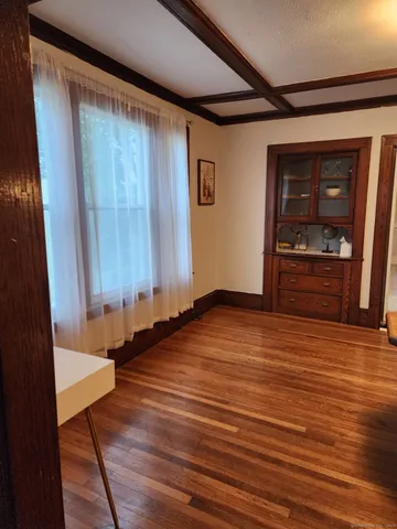 a view of a room with wooden floor and chair