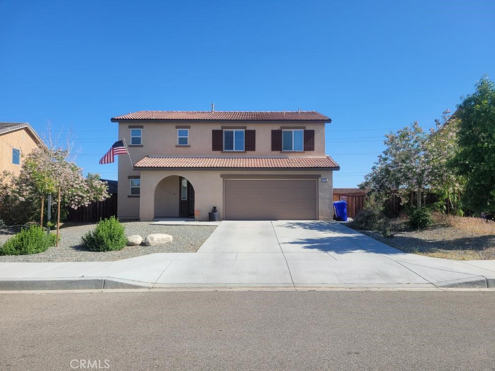 11107 Rio Seco Court Adelanto, CA 92301 - Photo 1 of 1 a front view of a house with a yard and garage