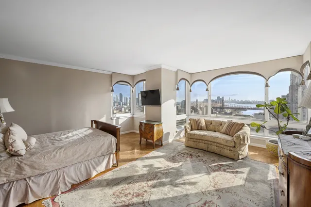 a bedroom with furniture and a large window