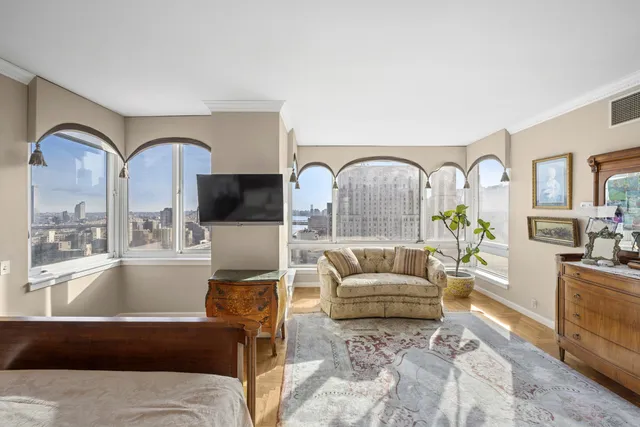 a living room with furniture a couch and a potted plant