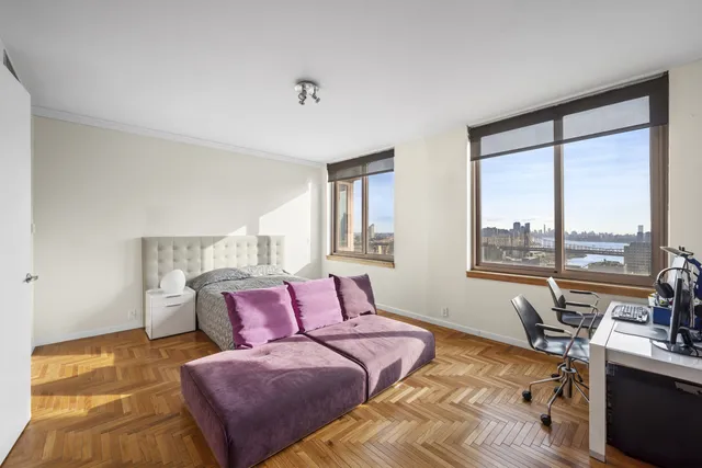 a bedroom with furniture and a large window