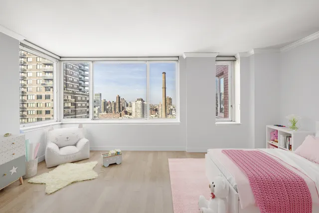 a bedroom with a bed and a large window